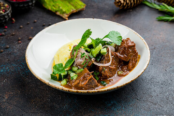Beef cheeks with mashed potatoes on plate