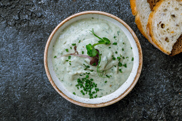 forshmak of herring with bread on dark stone table top view