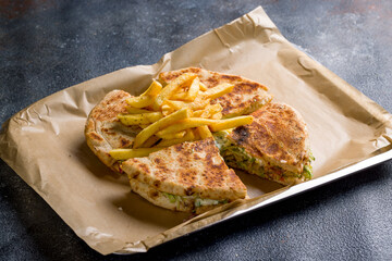 skepasti with chicken, french fries and pita, Greek cuisine on dark table