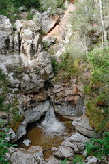 karst rocks in the forest with falling water flow