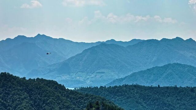 Helicopter Flies Fast Over Green Hilltop