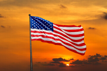 USA flag waving against sunset sky