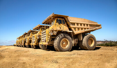 Large dump trucks in a row at a construction site 007