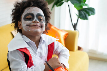 Close up face of African boy dress up as a scary Halloween vampire in a Halloween party, little boy...