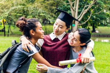 Successful of student young woman and bachelor gowns with diplomas graduate hugging her friend at university.Celebrating graduation and education concept