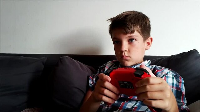 Boy Is Playing Video Game On Nintendo Switch Gaming Console