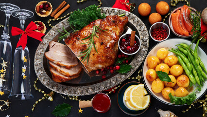 Traditional Christmas dinner on dark background.