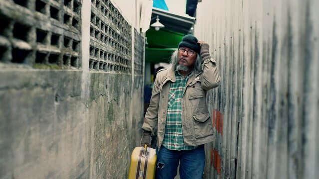 Beggar homeless aged man upset, stress no money walk Keep walking aimlessly, unemployed miserable old man read business newspaper, crisis social economic problem human right people on the footpath
