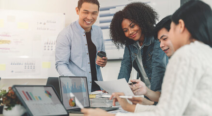 diverse coworkers working together in boardroom, brainstorming, discussing and analyzing business strategy.