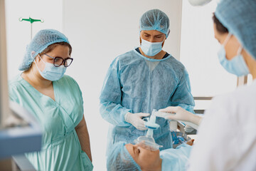 Well-trained anesthesiologist follows the patient during the surgery in clinic