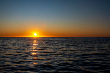 Amazing sunset on the Atlantic Ocean. The sun reflected in the waves