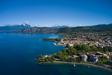 Fototapeta na wymiar Aerial view of Bardolino, Lake Garda, Italy. Top view of the historic part of the city of Bardolino on the coastline of Lake Garda. Panorama of the historic town of Bardolino.