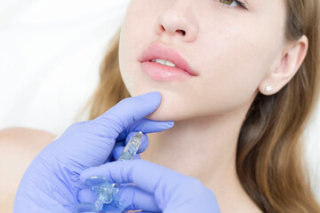 The cosmetologist makes anti-aging injections against wrinkles on the chin, cheeks and neck. Women's aesthetic cosmetology.