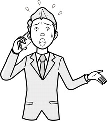 焦って携帯電話をかけるビジネスマン