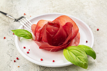 Meat Rose made from Slices of Bresaola, air dried salted italian beef cold cut. Close up.