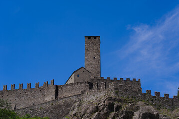 Fototapeta na wymiar Scenic view of Unesco world heritage castle Castelgrande at City of Bellinzona, Canton Ticino, on a blue cloudy summer day. Photo taken July 4th, 2022, Bellinzona, Switzerland.