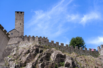 Obraz premium Scenic view of Unesco world heritage castle Castelgrande at City of Bellinzona, Canton Ticino, on a blue cloudy summer day. Photo taken July 4th, 2022, Bellinzona, Switzerland.
