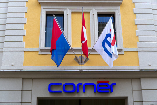 Logo of private Corner bank at City of Lugano on a cloudy summer day with Swiss flag and flag of Canton Ticino. Photo taken July 4th, 2022, Lugano, Switzerland.