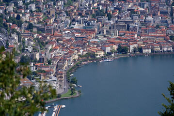 Fototapeta premium Aerial view of City of Lugano seen from local mountain San Salvatore on a sunny summer day. Photo taken July 4th, 2022, Lugano, Switzerland.
