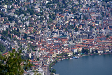 Fototapeta na wymiar Aerial view of City of Lugano seen from local mountain San Salvatore on a sunny summer day. Photo taken July 4th, 2022, Lugano, Switzerland.