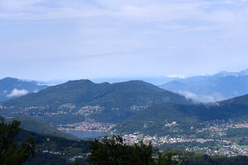 Aerial scenic view over region of Lugano, Canton Ticino, on a cloudy summer day. Photo taken July 4th, 2022, Lugano, Switzerland.
