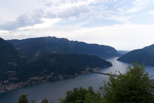 Aerial view from local mountain San Salvatore over region of Lugano, Canton Ticino, with Lake Lugano on a cloudy summer day. Photo taken July 4th, 2022, Lugano, Switzerland. © Michael Derrer Fuchs
