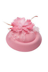 Close-up shot of a pink felt pillbox hat decorated with a flower, beads and feathers. The fascinator hat with an alligator clip is isolated on a white background. Front view.
