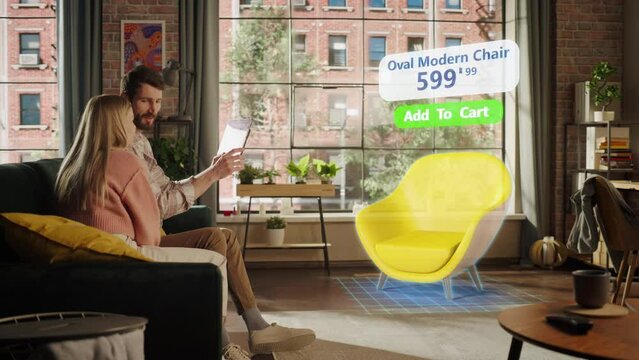 Decorating Apartment: Couple Holding Digital Tablet Computer, using Augmented Reality Interior Design Software Chooses 3D Furniture for Home. Pick a Stylish Chair for the Living Room. Side View
