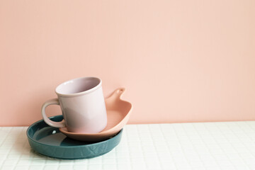 Home kitchen clean dishware on white table. pink wall background