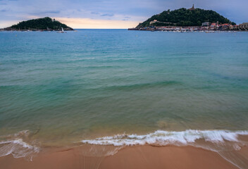 Waves at La Concha bay, beach and Santa Clara island in San Sebastian, Spain