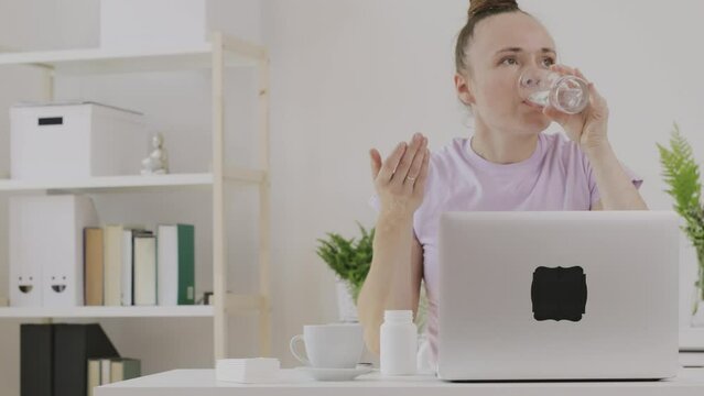 Young female between 30 and 40 years old spilled a glass of water on her pc