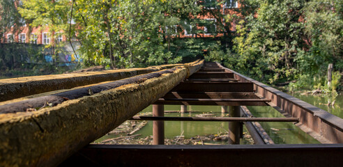 environmental pollution, rusty pipes across a dirty river