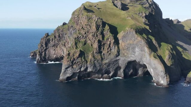 Stunning rock formation cliff on shore of Vestmannaeyjar island, aerial