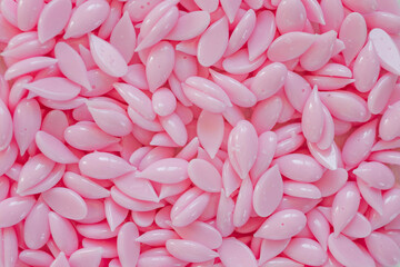 Obraz premium Beautiful pink depilatory wax. Epilation, depilation, removal of unwanted hair, eyebrows. View from above.