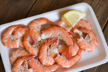 Seafood fresh shrimps on on plate plastic tray with lemon, boiled shrimp prawns cooked food, order food to go home takeaway restaurants food delivery concept