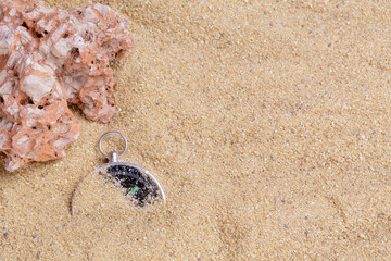 Compass in the sea sand on beach background with copy space for add text message or use components for design. Summer Travel destination and Navigation Concept Backdrop.