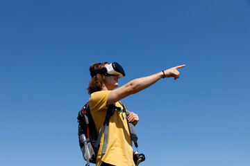 Young man enjoying nature with virtual reality simulator