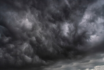Dramatic dark storm rain clouds black sky background. Dark thunderstorm clouds rainny atmosphere....