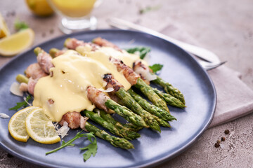 Healthy food - Asparagus wrapped with bacon and spices on a plate