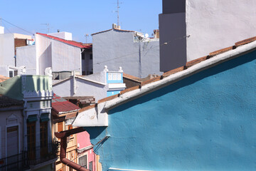 Fototapeta na wymiar Spanish small town landscape with colored houses and clear blue sky closeup photo