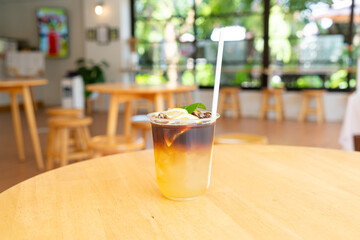 lemon with black coffee in glass
