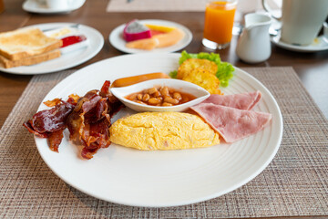 breakfast set - omelette, bacon, ham, sausages, fresh vegetable salad