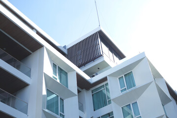 Modern urban apartment building exterior in evening.