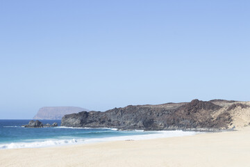 Naklejka na ściany i meble Playa de las Conchas with Mount Clara in the background. The island La Graciosa, Lanzarote, Canary Islands, Spain