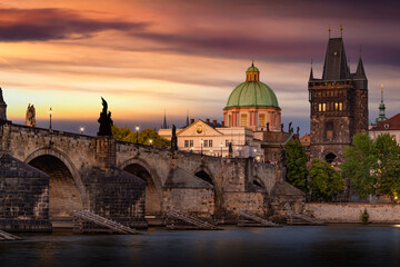 Colorful sunset view on old town, Charles bridge (Karluv Most - in czech) and Vltava river, Prague, Czech Republic.