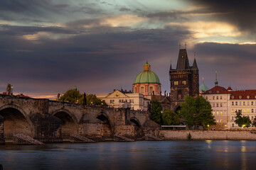 Colorful sunset view on old town, Charles bridge (Karluv Most - in czech) and Vltava river, Prague, Czech Republic.