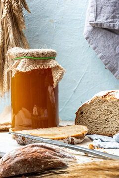 Natural Honey in jar and loaf of homemade bread