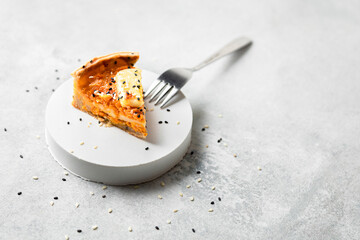 Studio shot of slice of butternut squash pie with sesame seeds