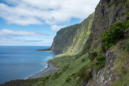 Portugal, Azores, Faja de Lopo Vaz beach and tall coastal cliffs ofFlores Island