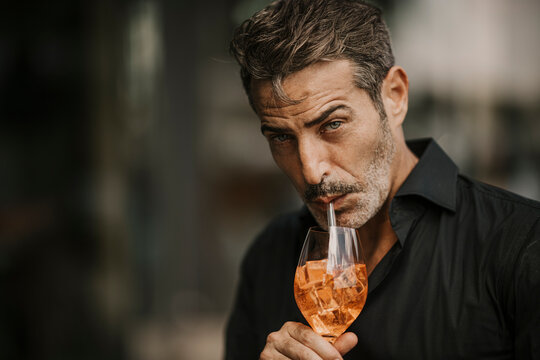 Handsome Mature Man Drinking With Straw